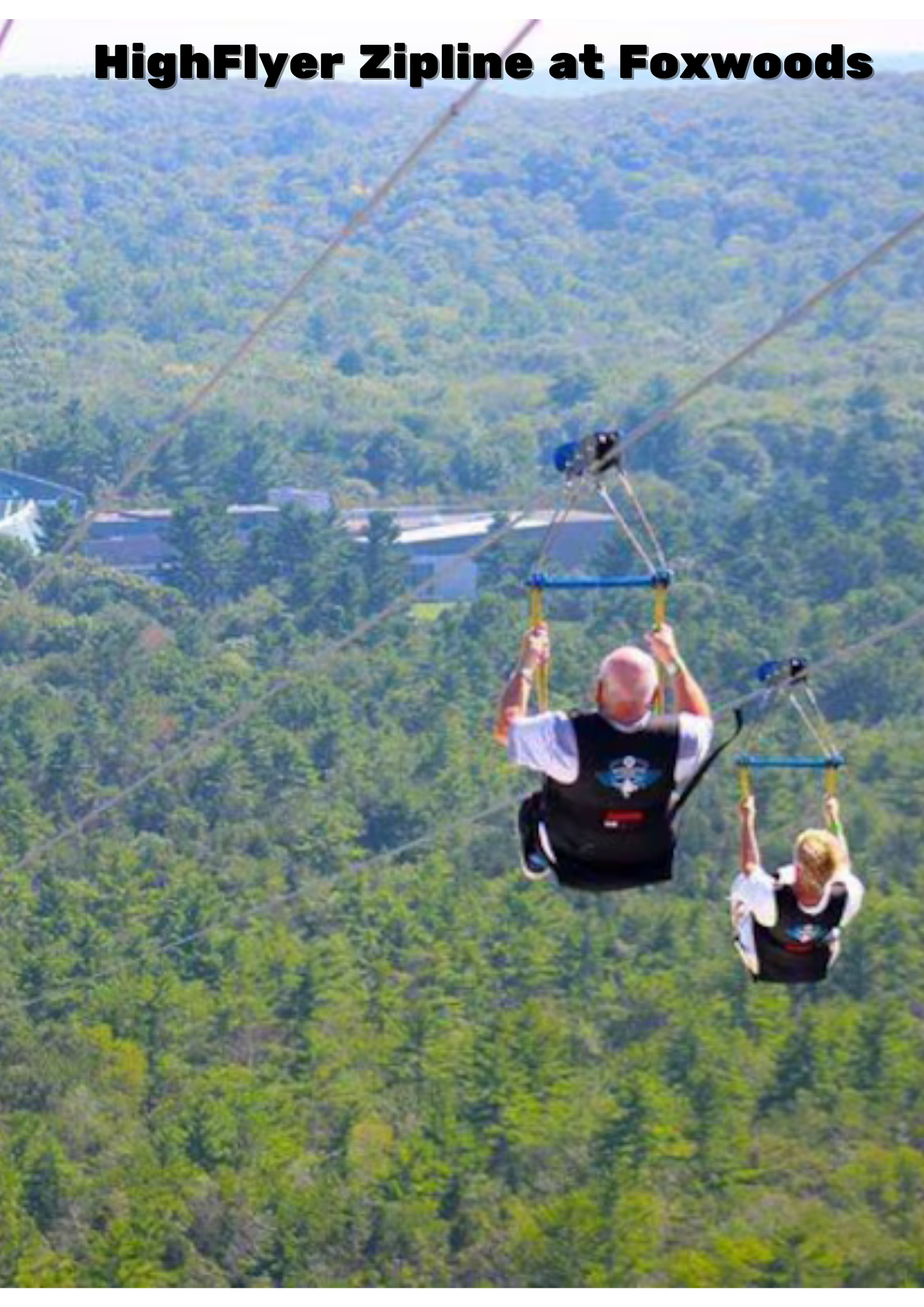 Two people ziplining through the treetops at Foxwoods, surrounded by lush green foliage.