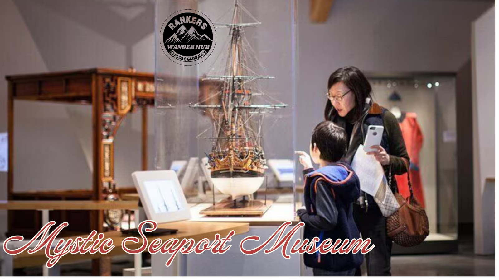 A woman and a child exploring a ship model at the Mystic Seaport Museum, showcasing maritime history.