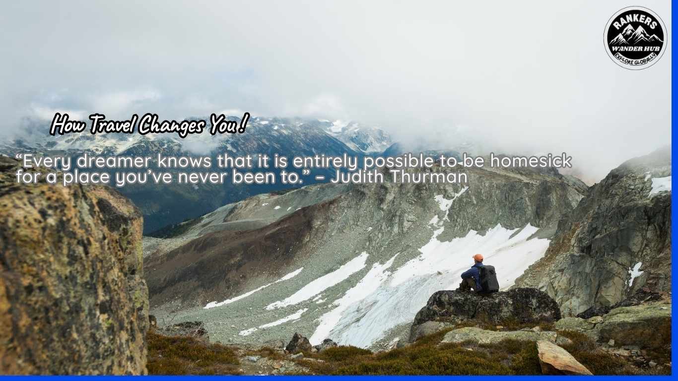 Traveler gazing at a mountainous valley with clouds hovering.