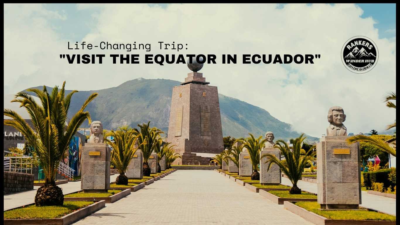 "Equator Monument at Mitad del Mundo, Ecuador, with palm trees and statues along a path leading to a central stone monument under a clear sky."